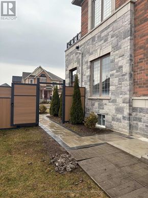 East Gwillimbury (Holland Landing) apartment for rent - A stone building with a gate in front of it.
