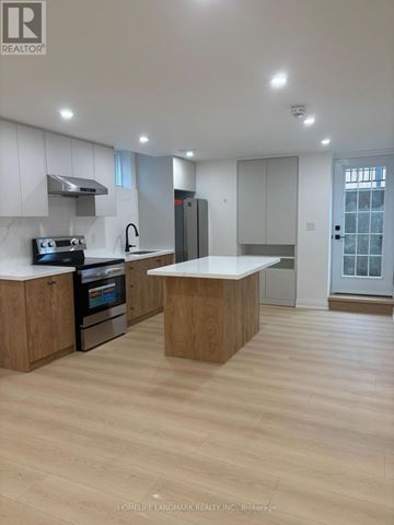 East Gwillimbury (Holland Landing) apartment for rent - A modern kitchen with wooden cabinets and a central island.