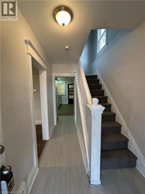 Hamilton apartment for rent - A hallway with a staircase and a light on the ceiling.