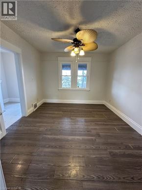 Hamilton apartment for rent - A room with wood flooring and a ceiling fan.