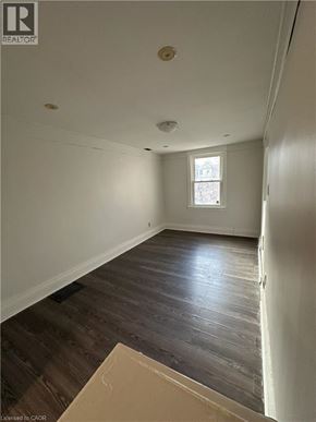 Hamilton apartment for rent - A room with wooden floors and a window.