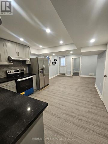 Markham (Cornell) apartment for rent - A kitchen with a black counter top and stainless steel appliances.