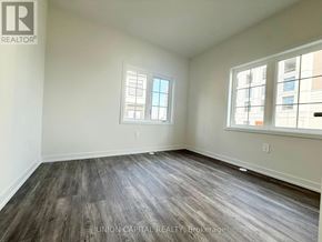Richmond Hill (Headford Business Park) townhouse for rent - A room with wooden flooring and two windows.