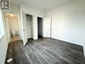 Richmond Hill (Headford Business Park) townhouse for rent - A room with wood flooring and white walls, with a toilet visible in the doorway.
