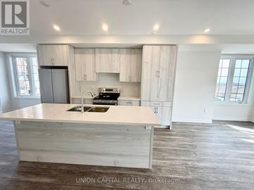 Richmond Hill (Headford Business Park) townhouse for rent - A kitchen with a sink and a stove top oven.
