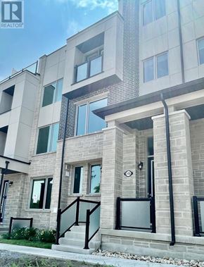 Markham (Victoria Square) townhouse for rent - A modern building with a glass door and windows.