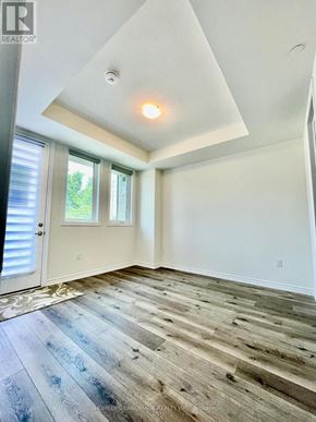 Markham (Victoria Square) townhouse for rent - A room with a wooden floor and a window with blinds.