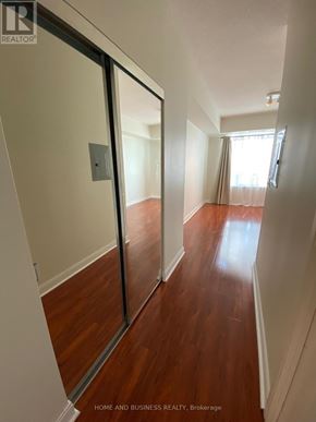 Mississauga (City Centre) condo for rent - A hallway with wood floors and white walls.