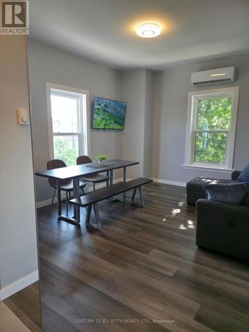 Orillia multi-family for rent - A living room with a table and chairs.