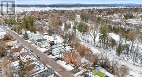Pembroke multi-family for rent - A winter scene of a residential area with houses and trees.
