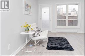 Oshawa (Lakeview) townhouse for rent - A white chair with a floral arrangement on a table in a room.