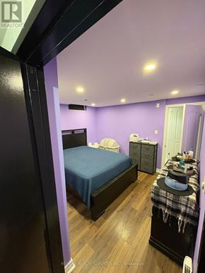 Oshawa (Lakeview) townhouse for rent - A bedroom with a bed, dresser, and nightstand.