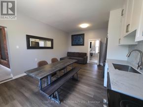 Orillia multi-family for rent - A kitchen with a table and chairs in the middle of the room.