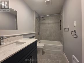 Orillia multi-family for rent - A bathroom with a white sink and a white toilet.