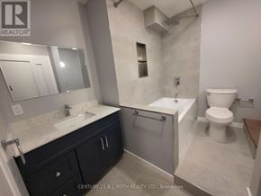 Orillia multi-family for rent - A bathroom with a sink, toilet, and bathtub.
