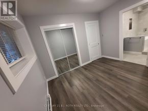 Orillia multi-family for rent - A room with a sliding door and a window with blinds.