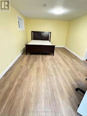 Toronto (Pleasant View) apartment for rent - A bedroom with a bed, wooden flooring, and a window.