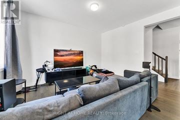 Ottawa townhouse for rent - A living room with a grey couch and a flat screen TV.