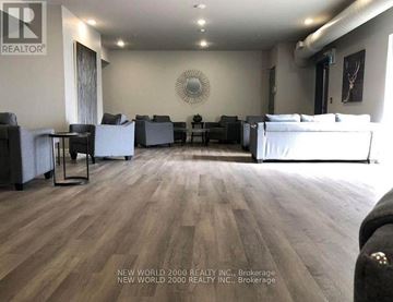 Kingston (East Of Sir John A. Blvd) condo for rent - A living room with a white couch and a wooden floor.