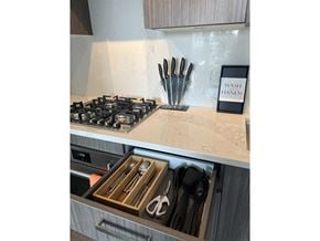 Surrey apartment for rent - A kitchen counter with a sign that says "Wash Hands" and utensils in a drawer.