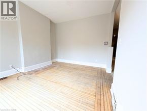 Hamilton apartment for rent - A room with wooden flooring and white walls.