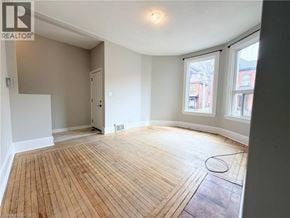 Hamilton apartment for rent - A room with wooden flooring and a slanted ceiling.