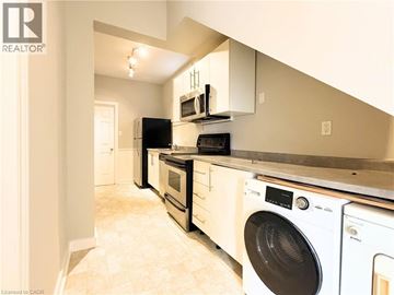 Hamilton apartment for rent - A realtor image of a kitchen with white appliances.