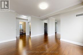 Toronto (York University Heights) condo for rent - A spacious room with wooden floors and white walls, part of a real estate listing.