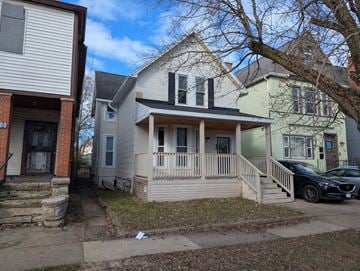 Buffalo apartment for rent - A house with a car parked in front.