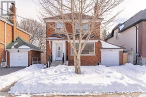 Toronto (O'connor-Parkview) apartment for rent - A house with a white garage door and a tree in front.