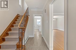 Toronto (O'connor-Parkview) apartment for rent - A hallway with a staircase and a doorway leading to another room.