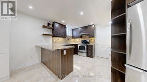 Markham (Cachet) apartment for rent - A modern kitchen with dark wood cabinets and stainless steel appliances.