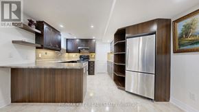 Markham (Cachet) apartment for rent - A modern kitchen with dark wood cabinets and stainless steel appliances.