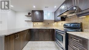 Markham (Cachet) apartment for rent - A kitchen with dark wood cabinets and a stove top oven.
