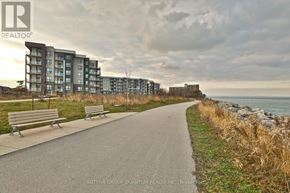 Hamilton (Stoney Creek) condo for rent - A pathway with benches and apartment buildings in the background.