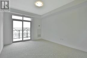 Hamilton (Stoney Creek) condo for rent - A room with a large window and a sliding glass door.
