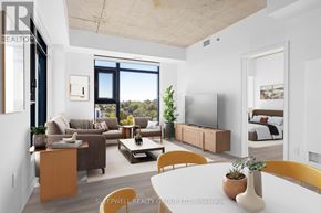Ottawa apartment for rent - A modern living room with a large window and a flat screen TV.