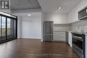 Ottawa apartment for rent - A modern kitchen with wooden floors and stainless steel appliances.