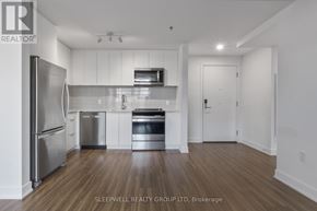 Ottawa apartment for rent - A modern kitchen with stainless steel appliances and wooden flooring.