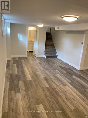Waterloo apartment for rent - A hallway with wood flooring and a staircase.