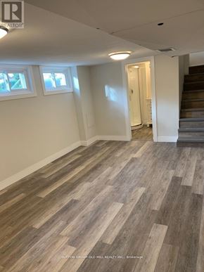 Waterloo apartment for rent - A room with wooden flooring and a staircase.