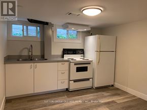 Waterloo apartment for rent - A kitchen with white cabinets and a white refrigerator.