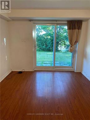 Toronto (Pleasant View) apartment for rent - A room with a sliding glass door leading to a green lawn.