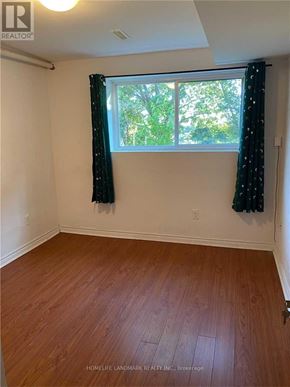 Toronto (Pleasant View) apartment for rent - A room with wooden flooring and a window with curtains.