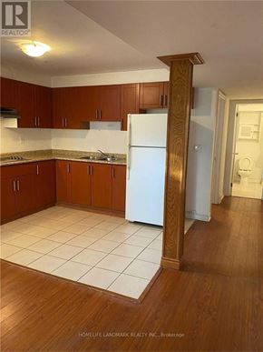 Toronto (Pleasant View) apartment for rent - A kitchen with wooden cabinets and a white fridge.