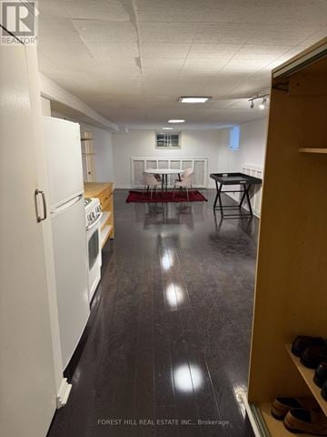 Toronto (Yonge-Eglinton) apartment for rent - A kitchen with white appliances and a dining table with chairs.