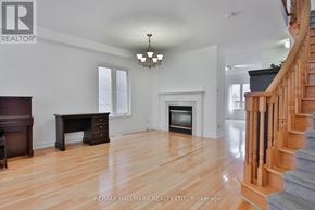 Markham (Cachet) apartment for rent - A spacious living room with a fireplace and a staircase.