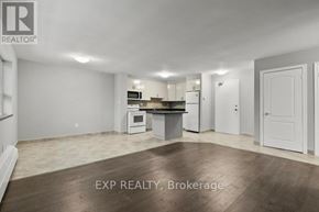 St. Catharines (Bunting/Linwell) multi-family for rent - A realtor photo of an empty room with a kitchenette.