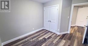 St. Catharines (Vine/Linwell) multi-family for rent - A room with a white door and a wooden floor.