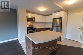 St. Catharines (Vine/Linwell) multi-family for rent - A kitchen with a refrigerator, microwave, and oven.